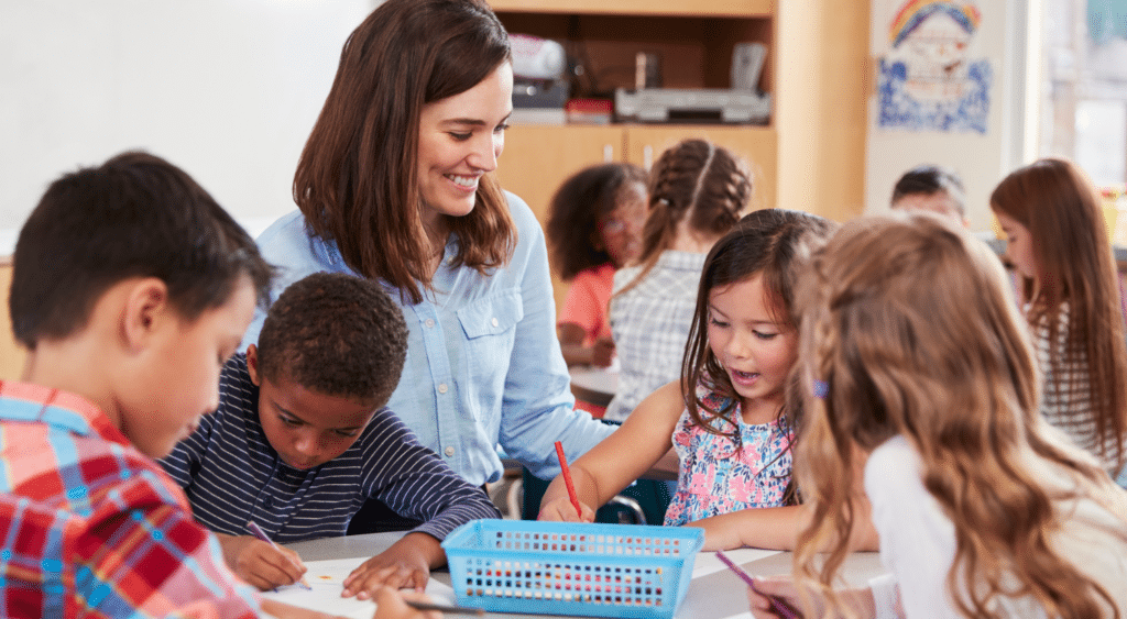 teacher with young students working on art