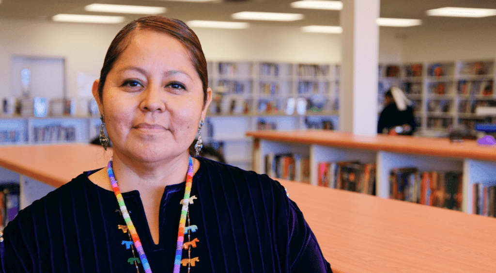 A teacher in a library.