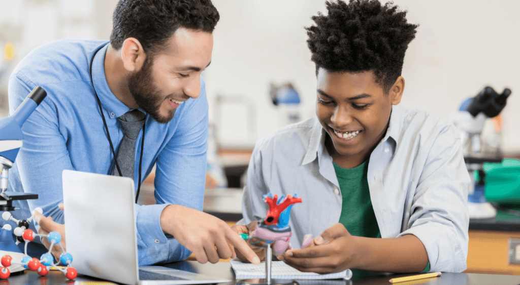 substitute teacher for science teacher with student looking at human anatomy model