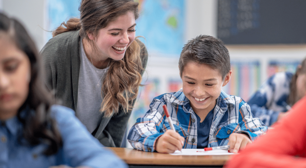 Teacher working with students on worksheet