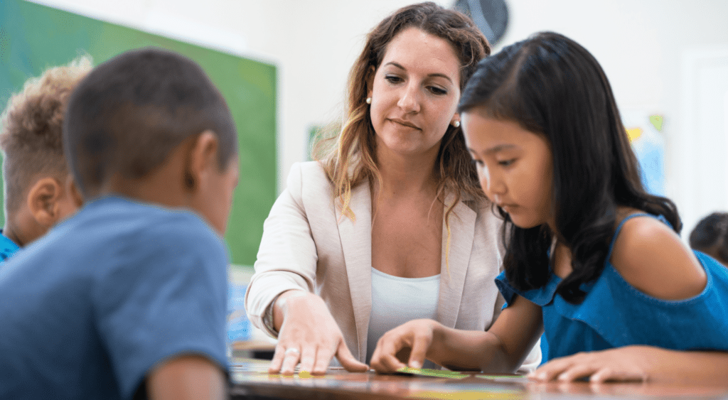 substitue teacher working with students at table