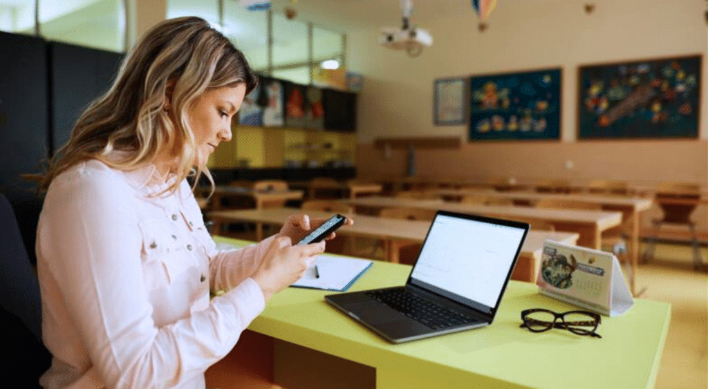 teacher with cellphone in classroom