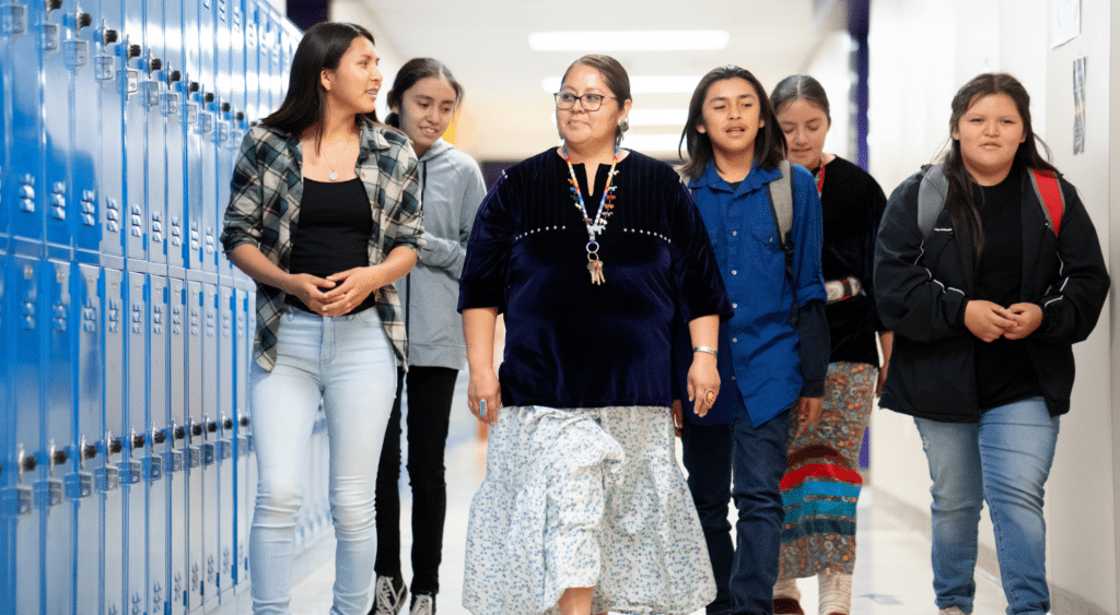 teacher in hall building relationship with high school students