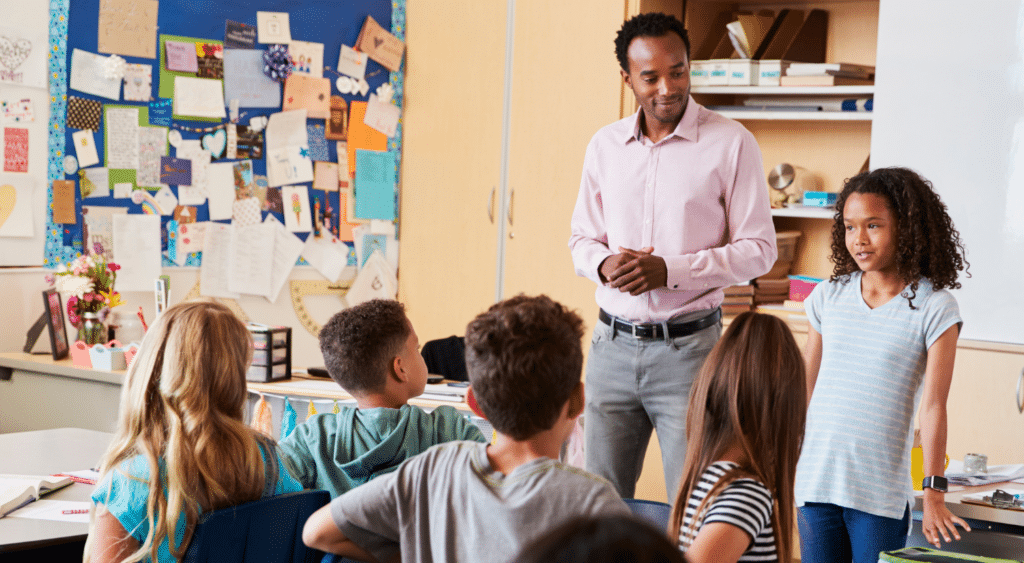 teacher with student in front of classroom