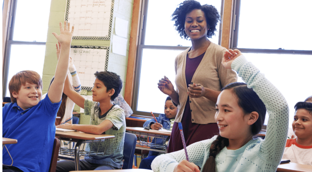 teacher getting attention of students in middle school