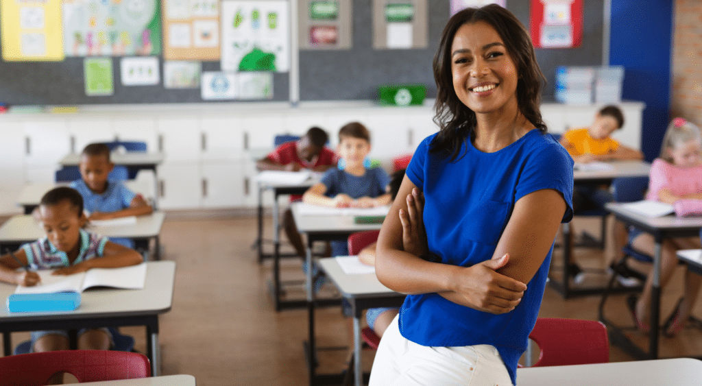 substitute teacher in champion pose in front of class