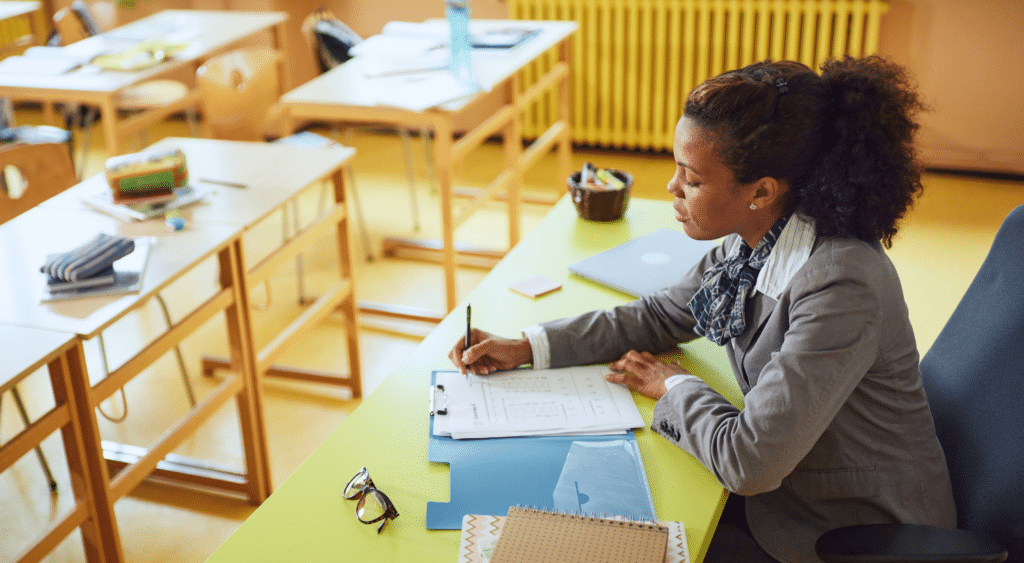 substitute teacher at desk leaving note