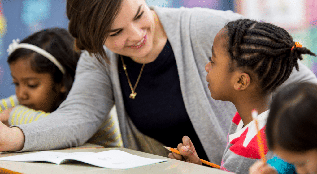 teacher talking to elementary school student to build relationship